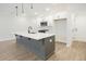 Modern kitchen with white cabinets, stainless steel appliances, and a large island at 907 Agate Ln, Lawrenceville, GA 30043