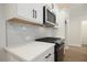 Sleek kitchen with white cabinetry, stainless steel appliances, and quartz countertops at 907 Agate Ln, Lawrenceville, GA 30043