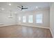 Bright and airy living room with hardwood floors, ceiling fan, and large windows at 907 Agate Ln, Lawrenceville, GA 30043
