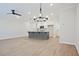 Open living space with hardwood floors, ceiling fan, chandelier, and access to kitchen at 907 Agate Ln, Lawrenceville, GA 30043