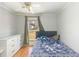 Cozy bedroom with a double bed, dresser, and large window at 348 Pine Forest Dr, Lawrenceville, GA 30046