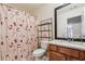 Clean bathroom with wood vanity and shower/tub combo at 3547 Valley Bluff Ln, Snellville, GA 30039