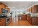 Spacious kitchen with stainless steel appliances and wood cabinets at 3547 Valley Bluff Ln, Snellville, GA 30039