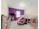 bedroom with bunk bed, play area, and purple wall at 7560 Rutgers Cir, Fairburn, GA 30213