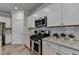 Modern kitchen with granite countertops, stainless steel appliances, and white cabinets at 2908 Rambler Dr, Loganville, GA 30052