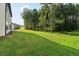 Large backyard with grassy area and wooded backdrop at 7265 Eton Ln, Locust Grove, GA 30248