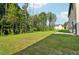 Large backyard with grassy area and wooded backdrop at 7265 Eton Ln, Locust Grove, GA 30248