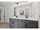 Elegant bathroom with a double vanity and grey cabinets at 7265 Eton Ln, Locust Grove, GA 30248