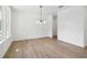 Simple dining room with hardwood floors and a modern chandelier at 7265 Eton Ln, Locust Grove, GA 30248