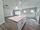 White kitchen island with a view of the living room at 5465 Rock Place Ct # 41, Norcross, GA 30093