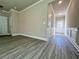 Bright living room with gray wood-look floors and white trim at 5465 Rock Place Ct # 41, Norcross, GA 30093