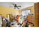 Yellow bedroom with ceiling fan, bed, dresser, and closet at 714 Lanford Springs Sw Dr, Lilburn, GA 30047