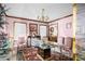 Dining room with glass-top table, pink chairs, and chandelier at 714 Lanford Springs Sw Dr, Lilburn, GA 30047