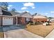 Front view of charming brick home with driveway and lawn at 242 Tara Woods Dr, Riverdale, GA 30274