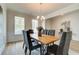 Elegant dining room with wood table and dark chairs at 307 Collier Mill Road, Lawrenceville, GA 30045