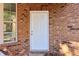 White front door with sidelights, located on a brick facade at 4499 Lombard Rd, Ellenwood, GA 30294