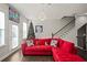 Spacious living room featuring a red sectional sofa, hardwood floors, and a Christmas tree at 616 Morning Glory Ne Pl, Atlanta, GA 30324