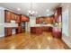 Eat-in kitchen with hardwood floors, granite counters, and ample cabinetry at 965 Gardiner Cir, Suwanee, GA 30024