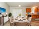 Virtually staged dining room with beige chairs and table at 1034 Sandy Ridge Rd, Mcdonough, GA 30252