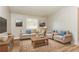 Virtually staged living room with beige furniture and wood flooring at 1034 Sandy Ridge Rd, Mcdonough, GA 30252