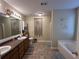 Bathroom with double vanity, garden tub, and decorative accents at 350 Chestnut Dr, Covington, GA 30016