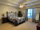 Main bedroom with ceiling fan, large window, and decorative wall art at 350 Chestnut Dr, Covington, GA 30016