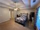 Main bedroom with ceiling fan, large window, and decorative wall art at 350 Chestnut Dr, Covington, GA 30016