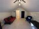 Spacious bonus room with a comfy couch and chair, perfect for relaxation at 350 Chestnut Dr, Covington, GA 30016