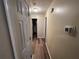 Hallway with light wood flooring and access to bathroom at 350 Chestnut Dr, Covington, GA 30016