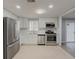 Modern kitchen with white cabinets and stainless steel appliances at 1337 Muirforest Dr, Stone Mountain, GA 30088
