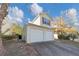 Tan house with a two-car garage and landscaping at 2213 Asquith Sw Ave, Marietta, GA 30008