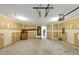 Unfinished garage with overhead storage and door to kitchen at 2213 Asquith Sw Ave, Marietta, GA 30008