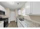 Modern kitchen featuring granite countertops and stainless steel appliances at 2213 Asquith Sw Ave, Marietta, GA 30008