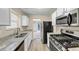 Eat-in kitchen with granite countertops and stainless steel appliances at 2213 Asquith Sw Ave, Marietta, GA 30008