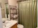 Bathroom with shower, toilet, sink, and storage rack at 2910 Evergreen Eve Xing, Dacula, GA 30019