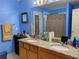 Blue bathroom with granite countertop, double vanity, and shower/tub combo at 2910 Evergreen Eve Xing, Dacula, GA 30019