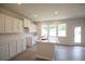 Island kitchen with white cabinets, quartz countertops, and stainless steel sink at 630 Edgemore Rd, Canton, GA 30114