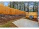 Fenced backyard with retaining wall and concrete patio at 1008 Rose Dr, Marietta, GA 30060