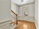 Bright foyer with hardwood floors, wainscoting, and a staircase with wrought iron railing at 3233 Nobility Se Way, Vinings, GA 30339