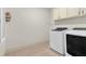 Laundry room with washer, dryer, and overhead cabinets at 3233 Nobility Se Way, Vinings, GA 30339