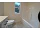 Bathroom with white vanity and quartz countertop, tiled flooring, and a tub/shower combo at 236 Harmony Ridge Dr, Temple, GA 30179