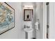 Small powder room with pedestal sink, framed art, and modern vanity at 2693 Avanti Way, Decatur, GA 30035