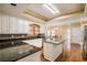 Kitchen with granite countertops, white cabinets, and an island at 4299 Donerail Dr, Snellville, GA 30039