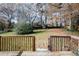 Large backyard with wooden deck, grassy area, and mature trees, viewed from the deck at 5760 Lakeview Dr, Powder Springs, GA 30127