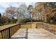 Spacious backyard with trees, wooden deck, and a storage building at 5760 Lakeview Dr, Powder Springs, GA 30127