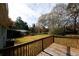 Wooden deck overlooking a spacious, grassy backyard with mature trees at 5760 Lakeview Dr, Powder Springs, GA 30127