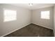 Spacious bedroom with neutral walls, carpeting, and two large windows at 5760 Lakeview Dr, Powder Springs, GA 30127