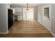 Open-concept dining and kitchen area with wood-look flooring and white cabinets at 5760 Lakeview Dr, Powder Springs, GA 30127