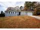 Single-story home with a gray exterior, black shutters, and a large front yard at 5760 Lakeview Dr, Powder Springs, GA 30127