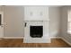 Close-up view of the white brick fireplace with a black metal screen at 5760 Lakeview Dr, Powder Springs, GA 30127